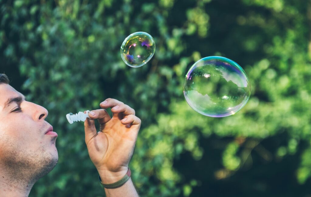 carefree man blowing bubbles